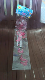 Butterfly Bell Wind Chime hanging in lush garden setting producing soothing sounds