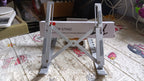A person comfortably working at a desk with their laptop elevated on the portable stand.