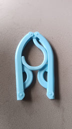 Single travel hanger shown in its fully compact, folded position for easy portability.
