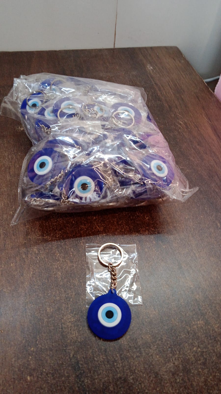 Blue evil eye silicone keychain accessory shown on white background