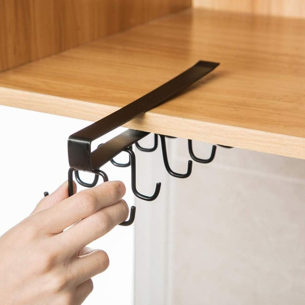 Double-row metal cup holder rack hanging mugs and cups in a modern kitchen.