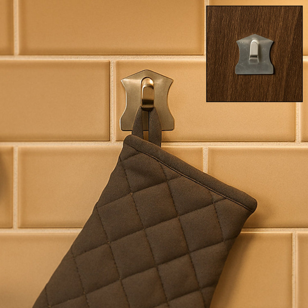 A set of sleek stainless steel wall hooks applied to a smooth, tiled surface.