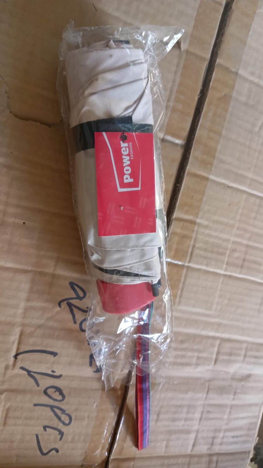 DrizzlePro foldable umbrella neatly tucked into its protective storage sleeve.