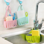 Adjustable plastic faucet sink caddy in a modern kitchen.