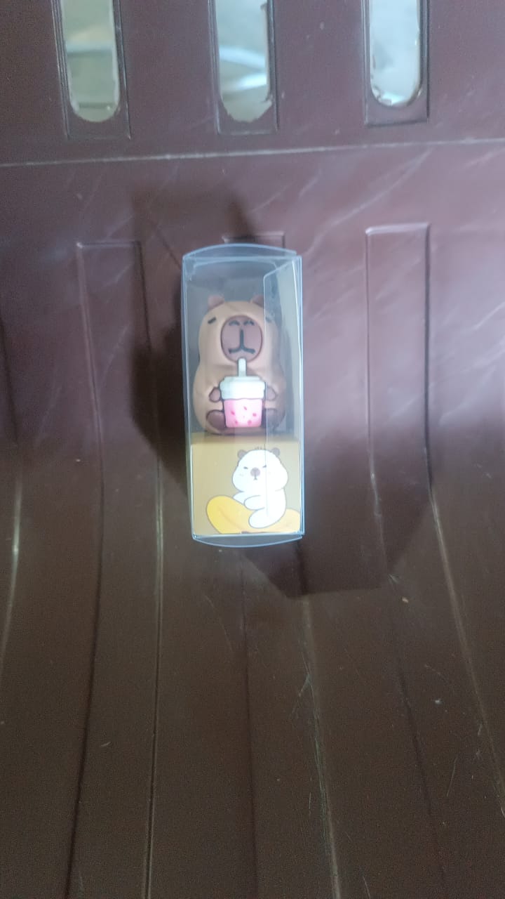 Cartoon pencil sharpener held in hand showing size and design