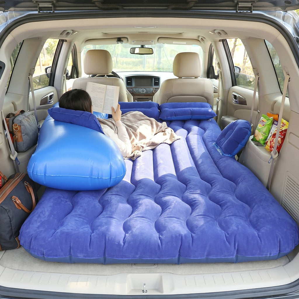 Couple relaxing on car air mattress during outdoor trip