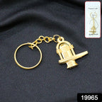 Close-up of golden Shivling metal keychain showing detailed craftsmanship