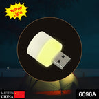 Portable yellow USB light bulb plugged into a laptop for office use.