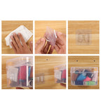 Two waterproof adhesive wall hooks neatly organizing keys and a small bag near an entrance.