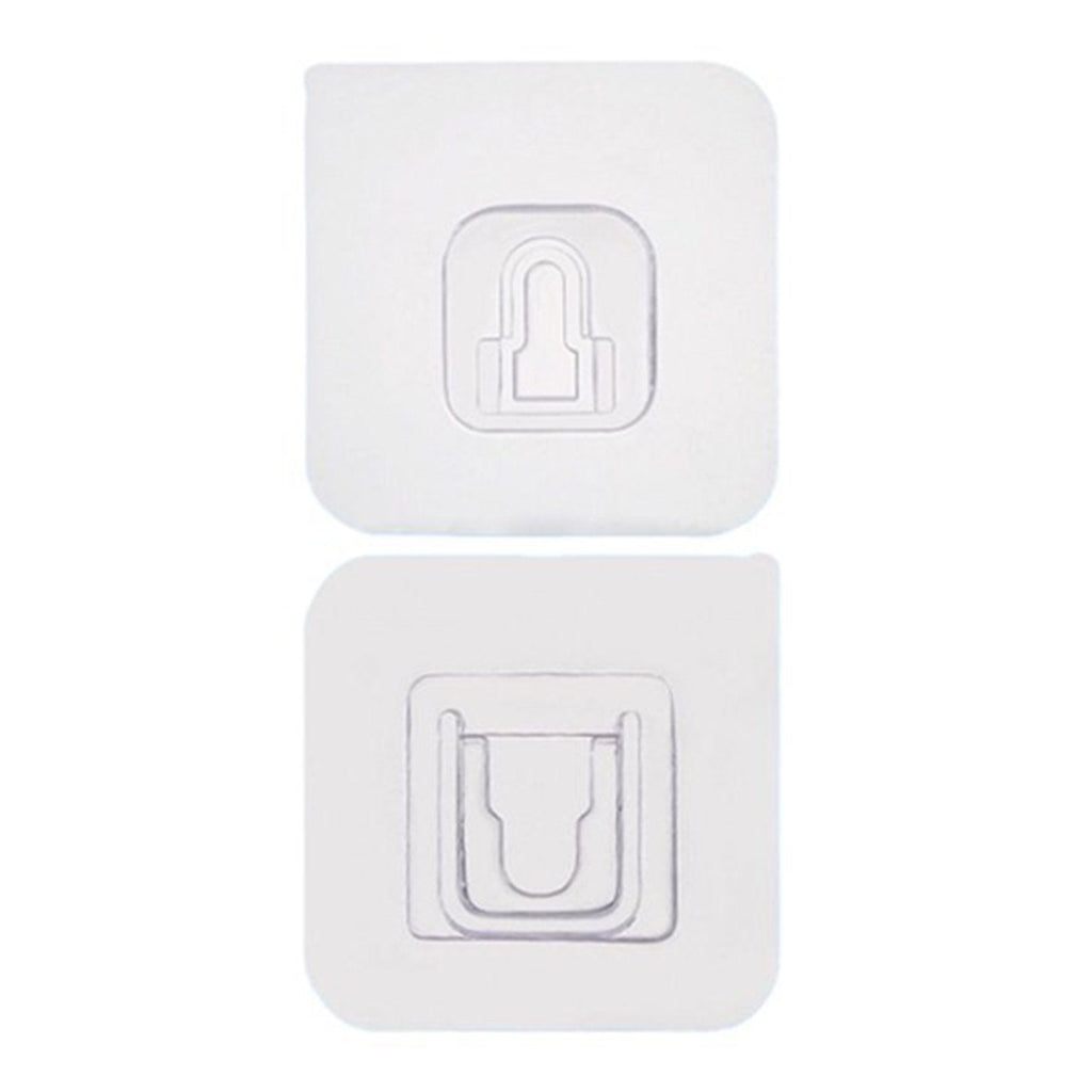 Two white no-drill adhesive hooks mounted on a smooth, clean wall surface.