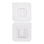 Two white no-drill adhesive hooks mounted on a smooth, clean wall surface.