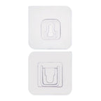Adhesive wall hooks holding various kitchen utensils, showcasing their versatile use.
