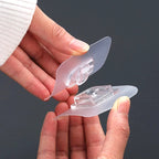 Close-up view of the strong adhesive backing on a white plastic wall hook.