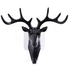 White deer head self-adhesive wall hook attached to a door, ready for use.