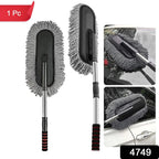 Person using the retractable car duster to clean a car's exterior.