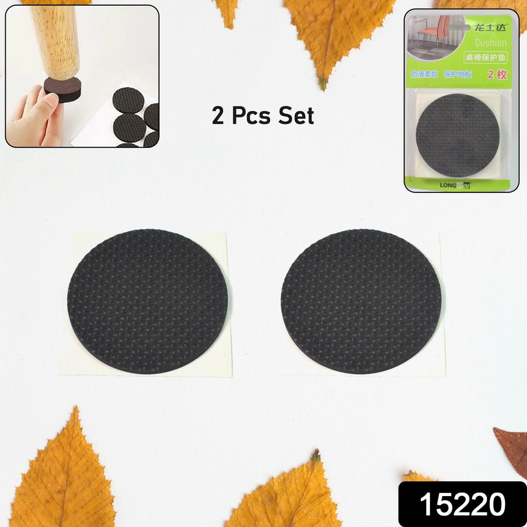 Round self-adhesive felt pads applied to a furniture leg for floor protection.