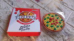 An overhead shot of the 7-piece Pizza Eraser Set, ideal for kids' stationery.