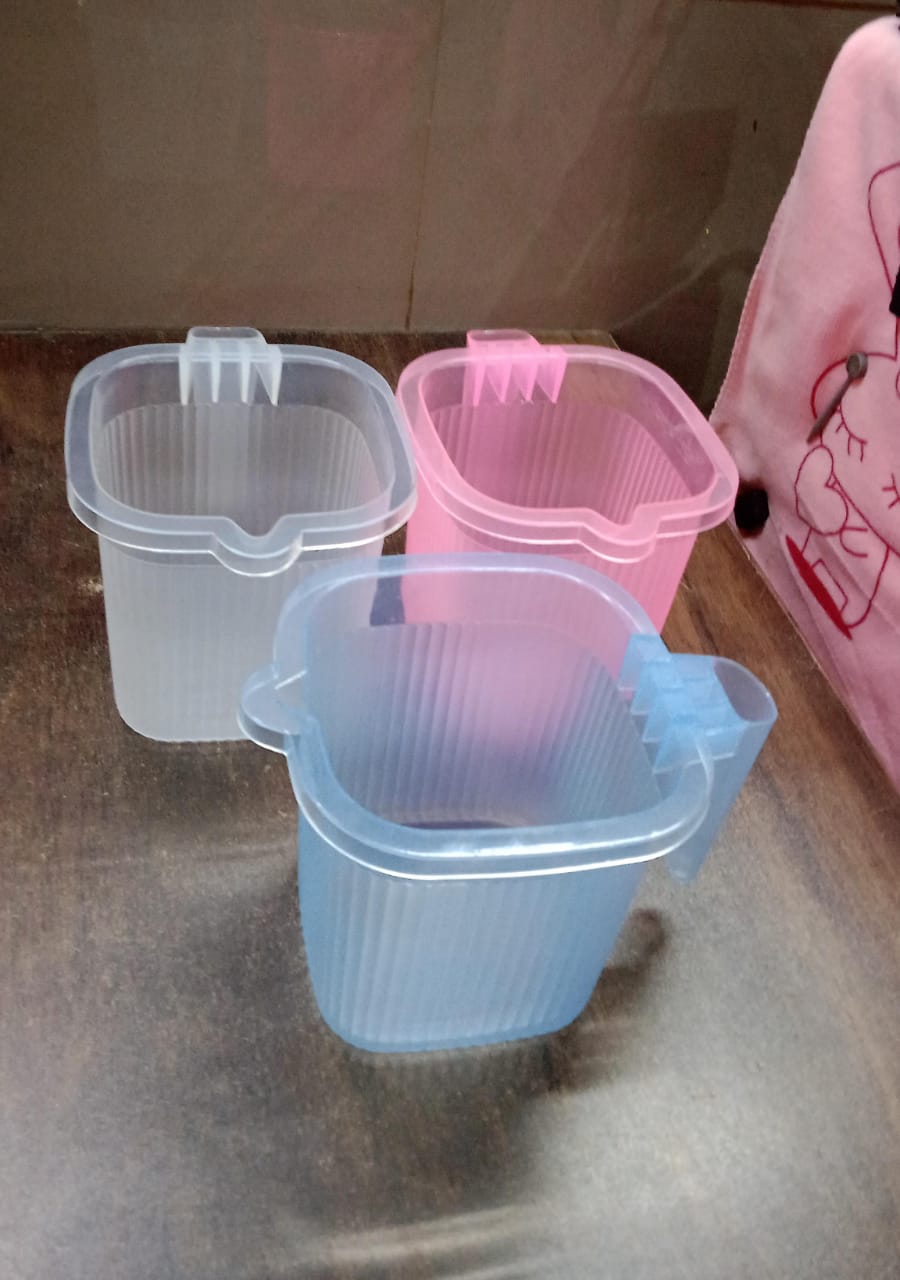 Stylish Transparent Bath Mug displayed in a modern bathroom setting.