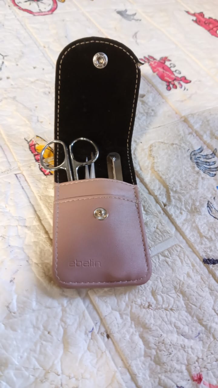 Full view of the 4-in-1 manicure set, showcasing all included stainless steel tools.