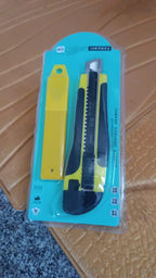 Cutter knife cutting a sheet of paper for precise craft work