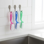 Kitchen cleaning brush effectively removing scales from a fish.