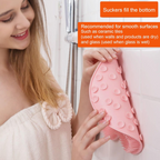 Soft silicone massage cushion used vertically on shower wall for back massage