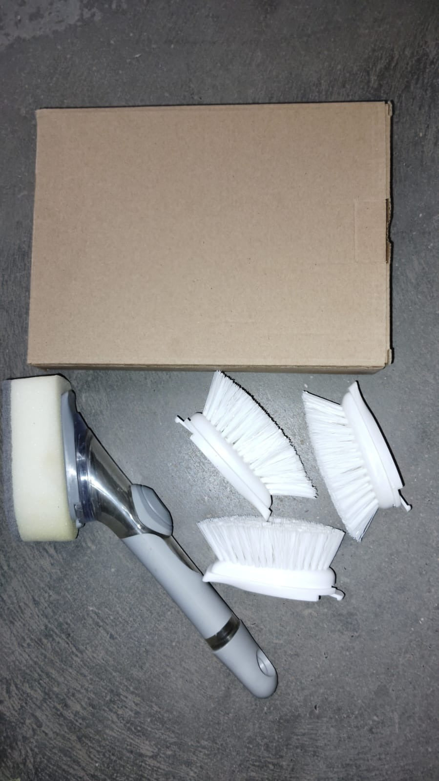 Versatile kitchen scrub brush cleaning tool with a convenient dispenser.