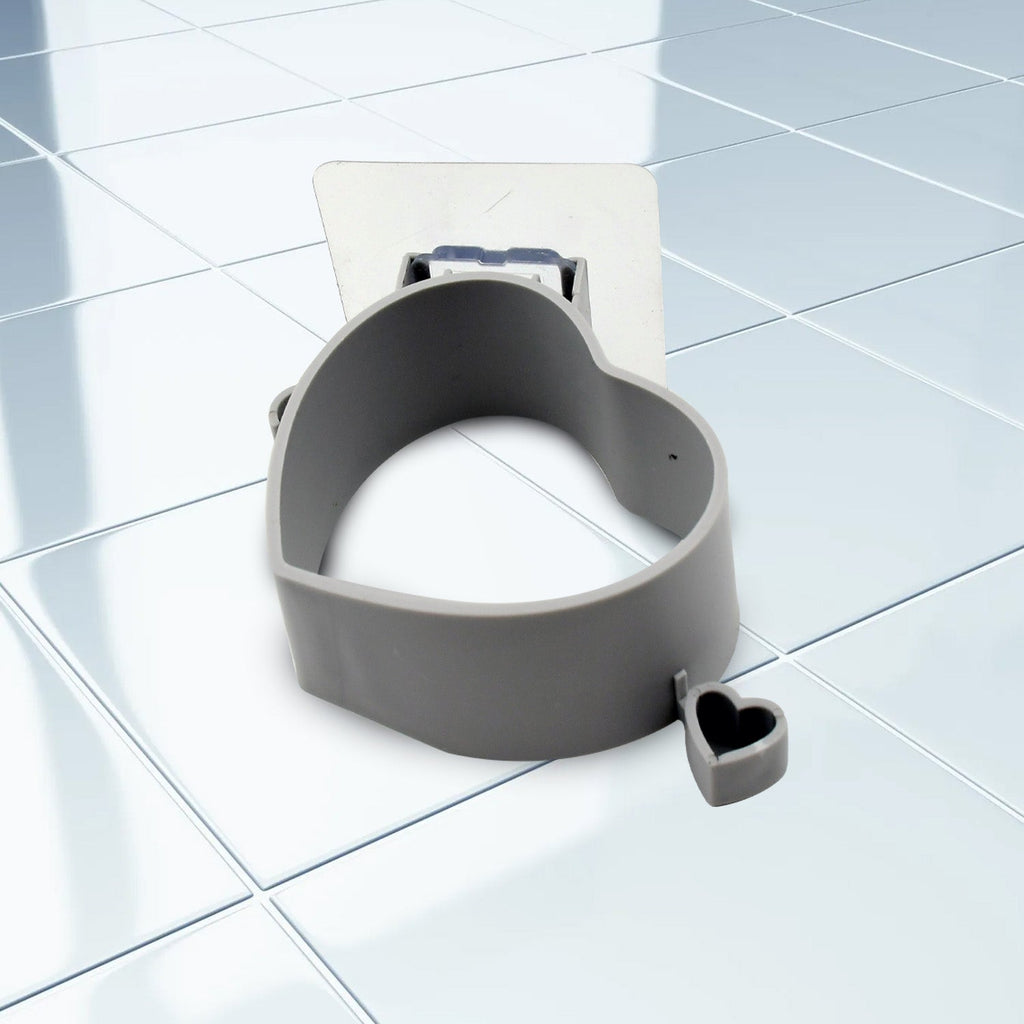 White adhesive hair dryer holder mounted on a smooth bathroom wall.