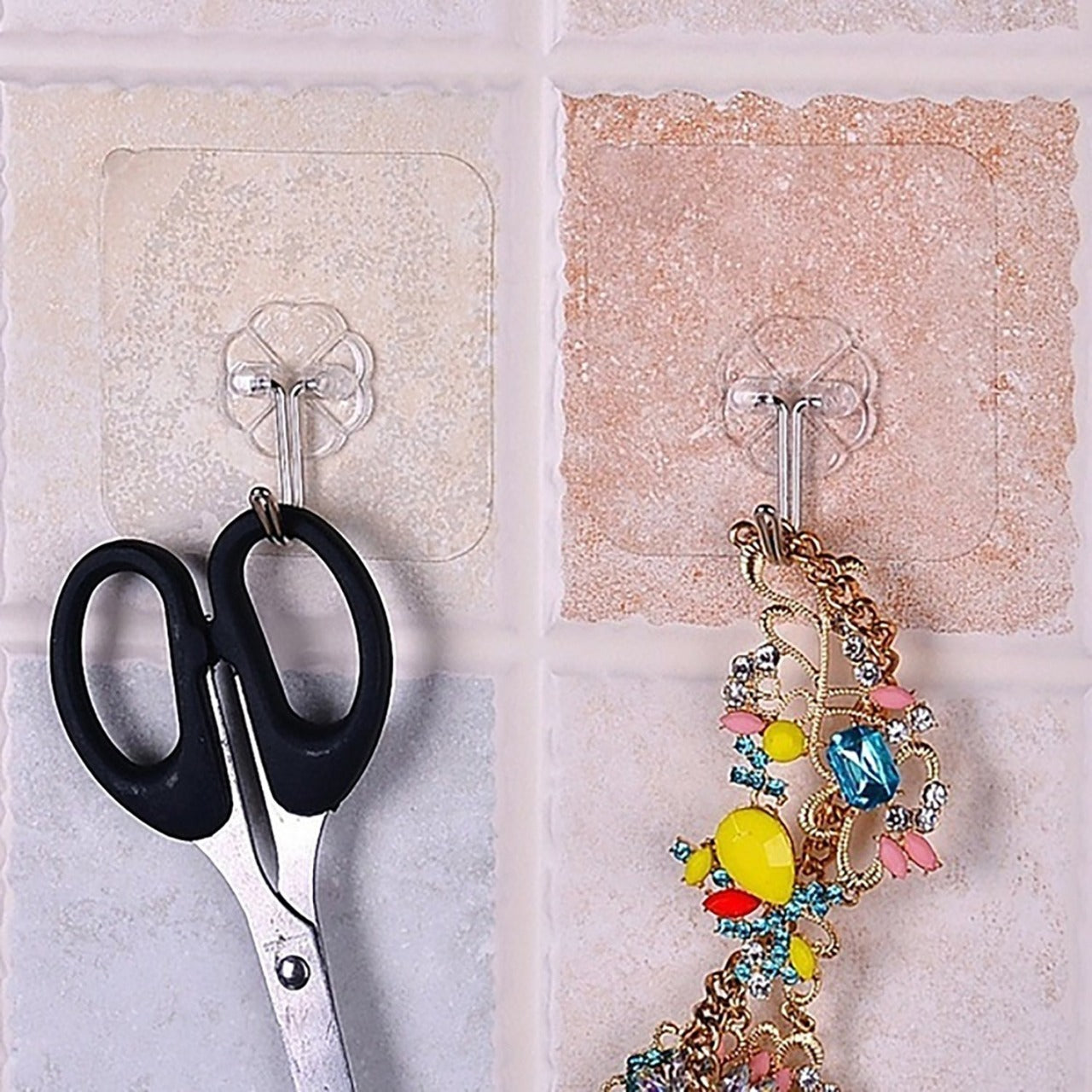 The full 100-pack of multipurpose stainless steel adhesive wall hooks, ready for use.