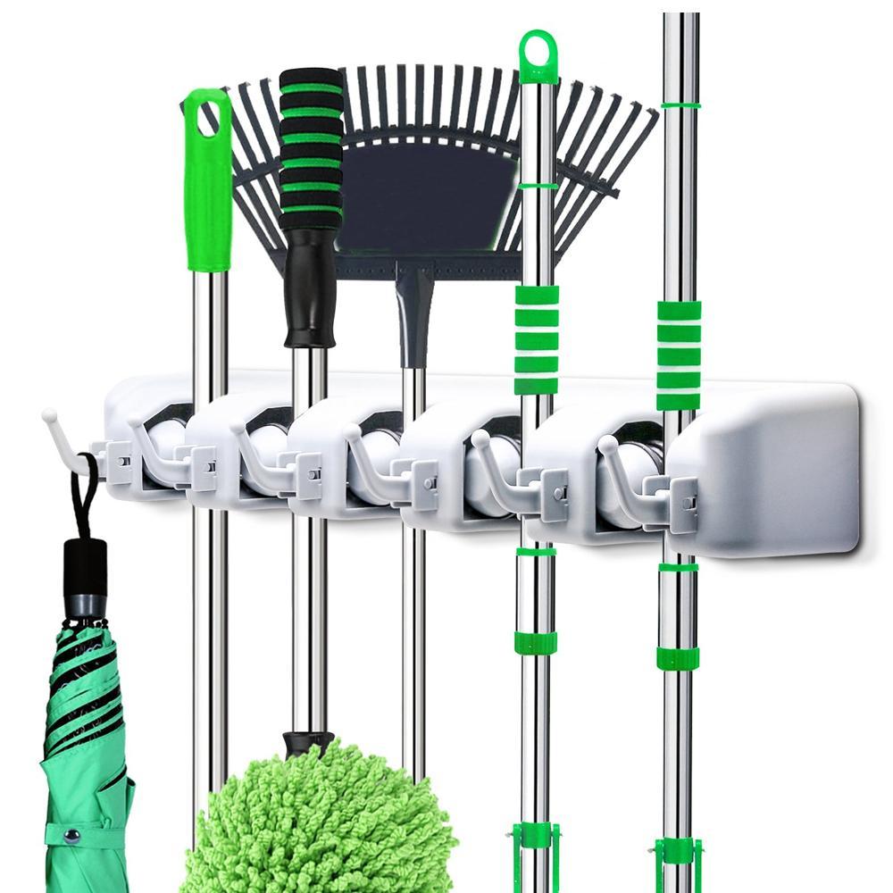 Wall mounted mop holder with 5 slots and 6 hooks for organized cleaning tools.