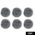 Heavy-duty stainless steel scrubber tackling tough grease on utensils.