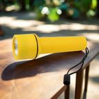 Compact LED flashlight standing upright, ready for emergencies.