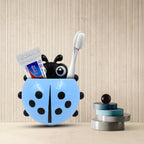 Ladybug toothbrush holder displayed on a clean ceramic bathroom tile.