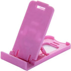 Portable foldable stand holding a mobile phone securely on desktop.