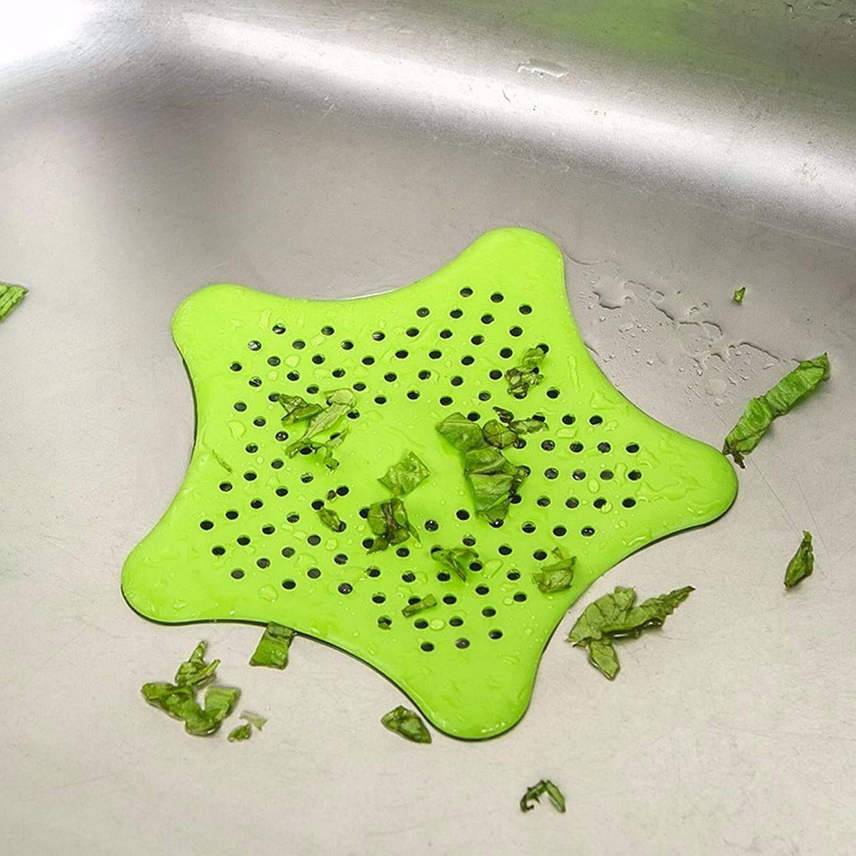 Star-shaped sink strainer in a kitchen sink, preventing clogs.