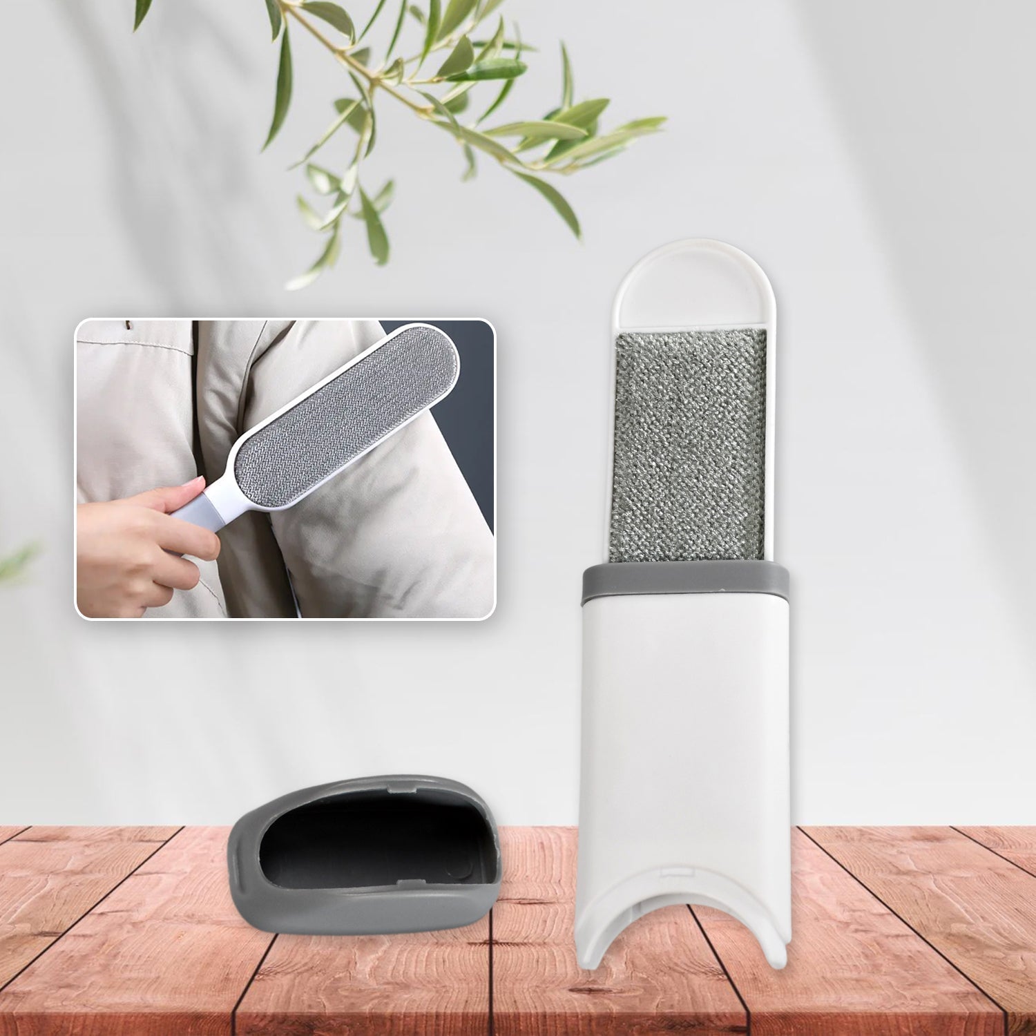 Double-sided lint remover brush effortlessly cleaning a dark sweater.