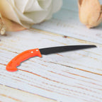 Compact hand pruning saw, ideal for gardening and camping.