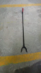 The pick up stick for elderly in a home setting, retrieving an item.