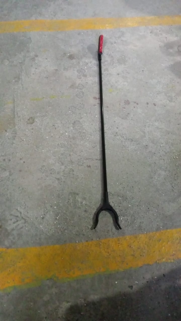 The pick up stick for elderly in a home setting, retrieving an item.