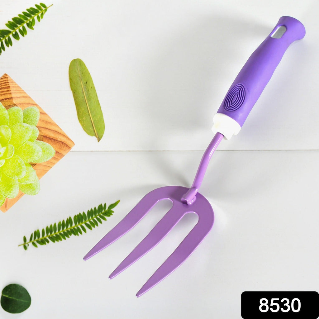 Sturdy metal cultivator from the garden tool kit for aerating soil.