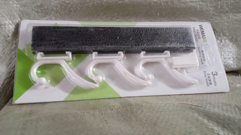 Detail view of the durable metal hooks and wooden board of the GlimmerHome coat rack