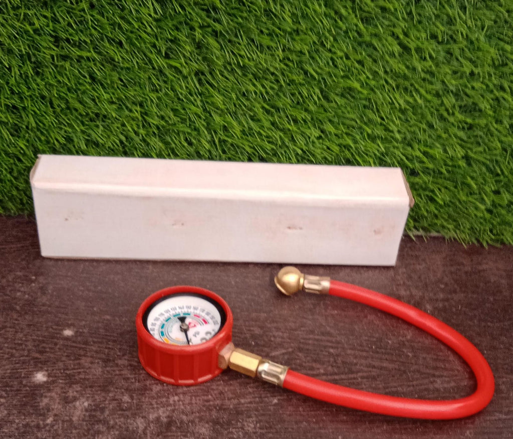 Analog tire inflator gauge clearly showing its PSI and kg/cm² measurement scales.