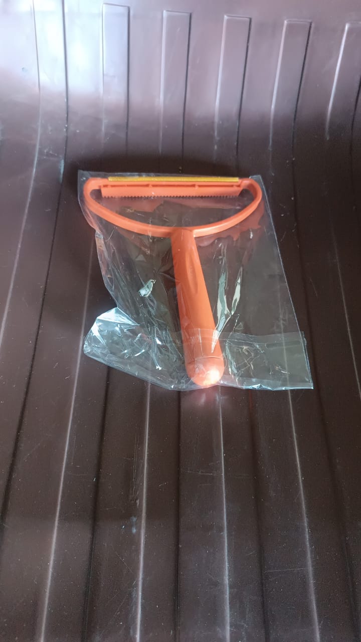 The 2-in-1 lint remover displayed with its packaging, ready for use.