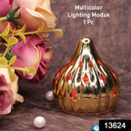 Close-up of a glowing Modak LED light, adding a warm ambiance to a festive setting.