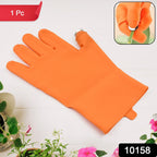 Right-Handed Thumb Cutter Glove being used to harvest a red chilli pepper from a plant.