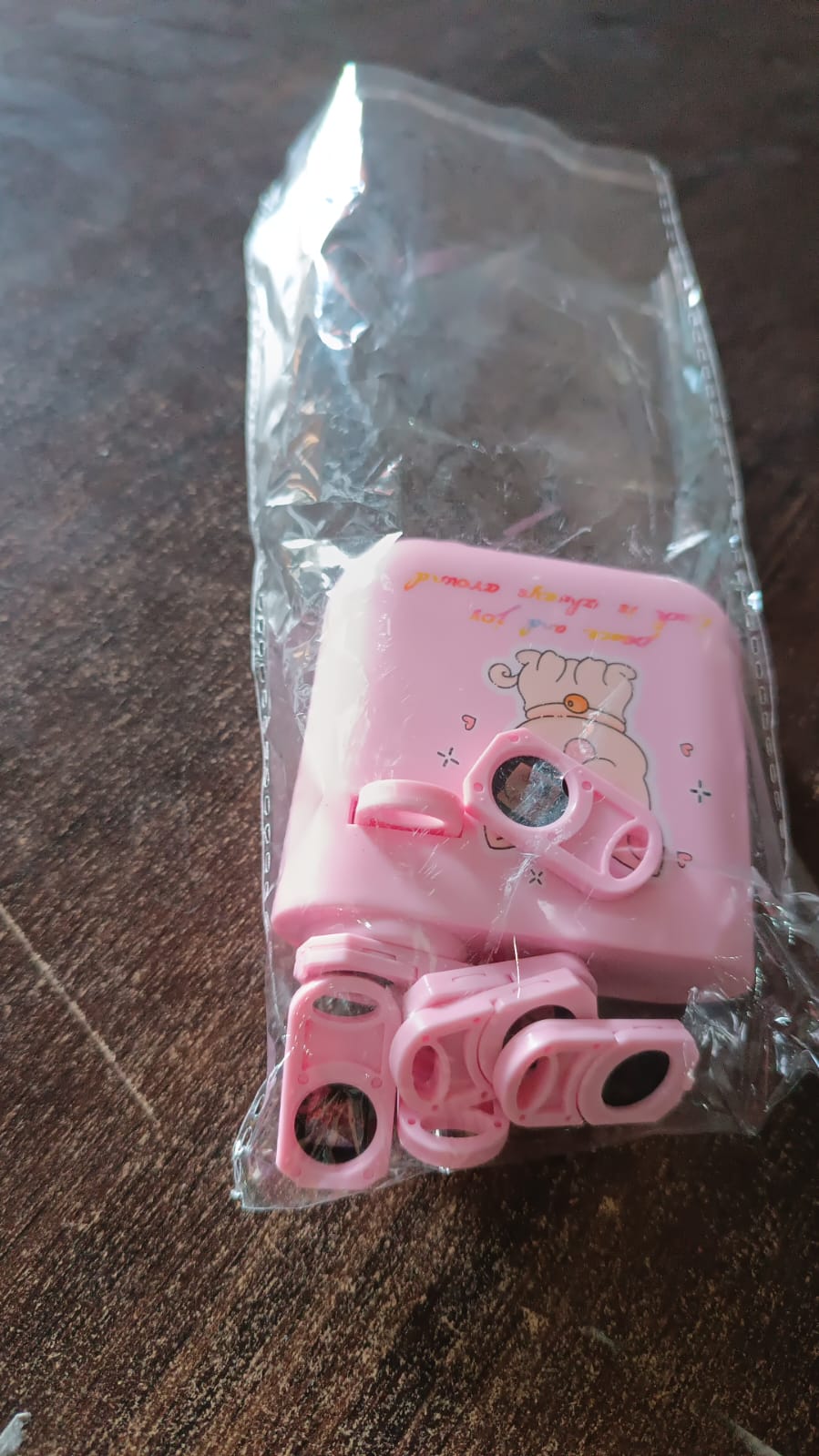 A hand holding the compact and portable GiftingGrace birthday projector.
