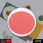 Close-up of a vibrant orange silicone hot mat with a textured design.