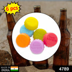 Assorted silicone bottle covers placed on different types of bottles.