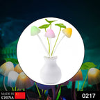 Close-up of a vibrant multicolor mushroom night light with artificial flowers.