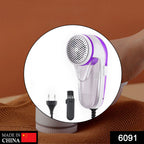 Close-up of the fabric shaver's stainless steel blade and comfortable grip.